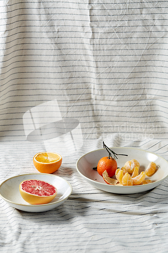 Image of still life with mandarins and grapefruit on plate