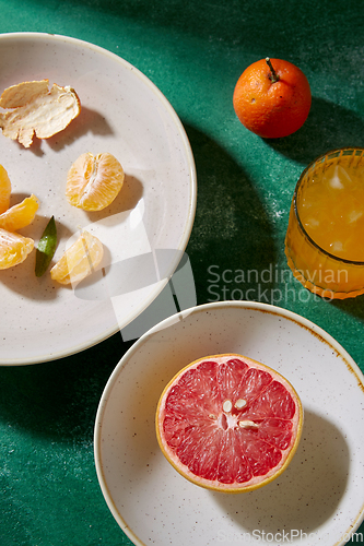 Image of mandarins, grapefruit and glass of juice