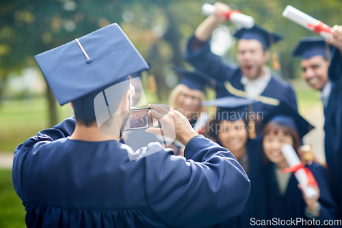 Image of graduate students taking photo with smartphone