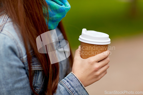 Image of close up of young woman drinking takeaway coffee