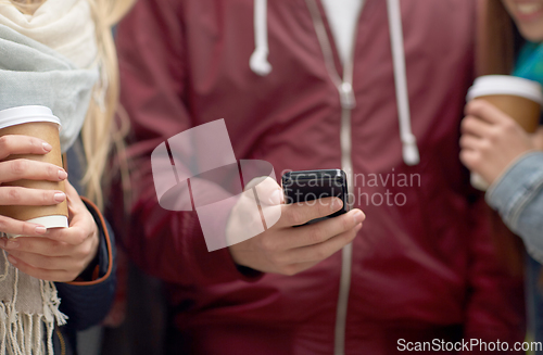 Image of friends with smartphone and coffee outdoors