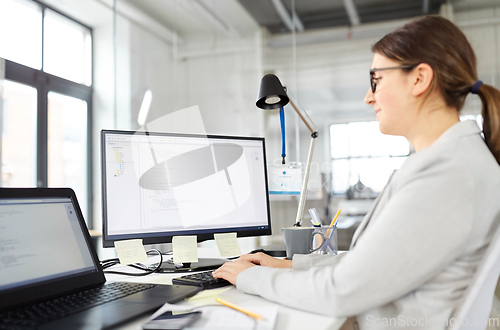 Image of businesswoman with computer working at office