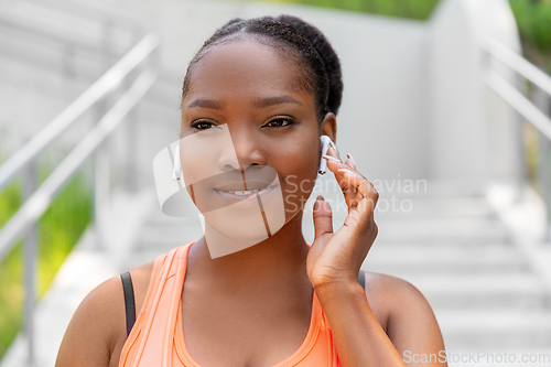 Image of happy african american woman with earphones