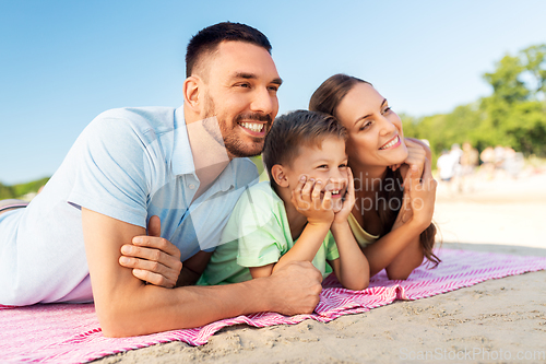 Image of family lying on summer beach