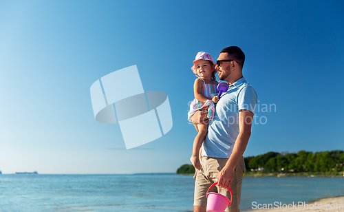 Image of happy father with little daughter on beach