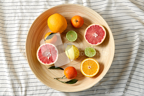 Image of close up of citrus fruits on wooden plate