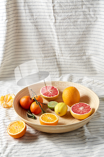 Image of close up of citrus fruits on wooden plate