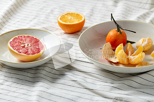 Image of still life with mandarins and grapefruit on plate