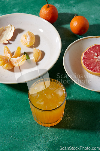 Image of mandarins, grapefruit and glass of juice