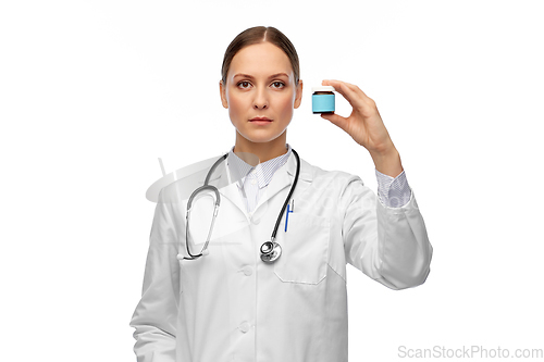 Image of female doctor holding jar of medicine