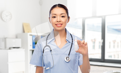 Image of smiling asian female doctor or nurse with medicine