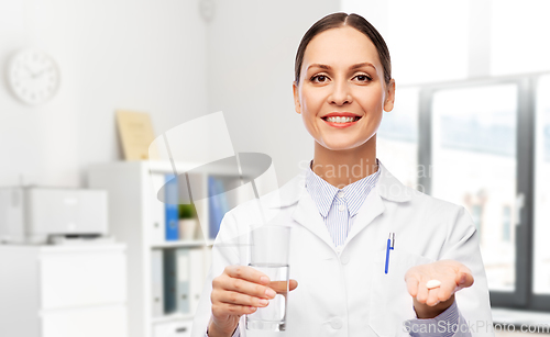 Image of female doctor with medicine and glass of water