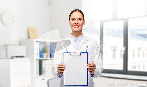 Image of smiling female doctor with clipboard at hospital
