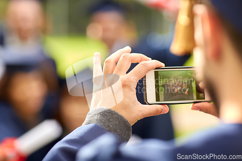 Image of graduate students taking photo with smartphone