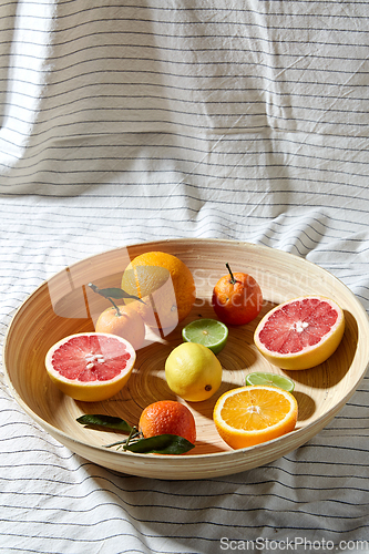 Image of close up of citrus fruits on wooden plate