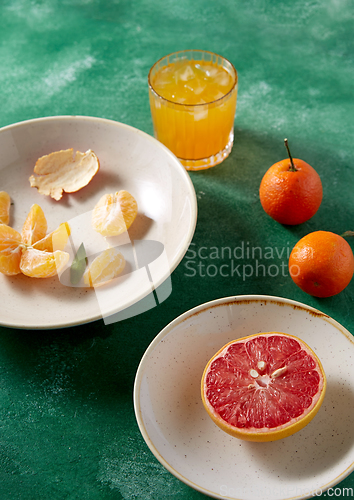 Image of mandarins, grapefruit and glass of juice