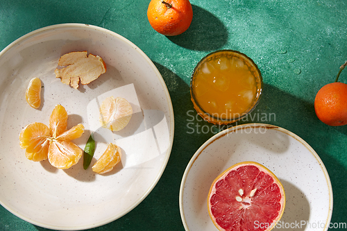 Image of mandarins, grapefruit and glass of juice