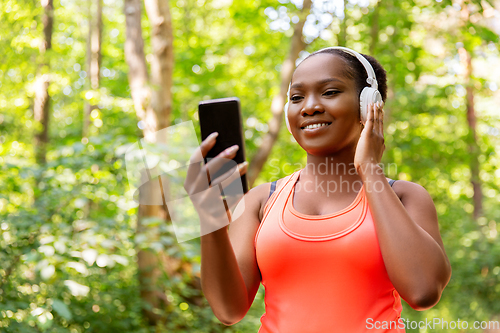 Image of african american woman with headphones and phone