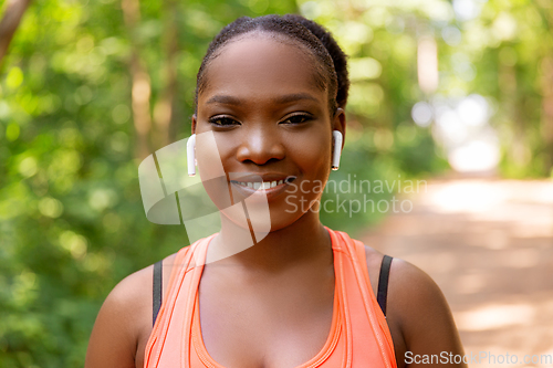 Image of happy african american woman with earphones