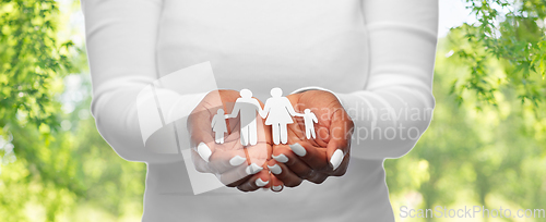 Image of hands of african american woman with paper family