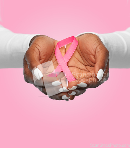 Image of hands of woman with pink cancer awareness ribbon