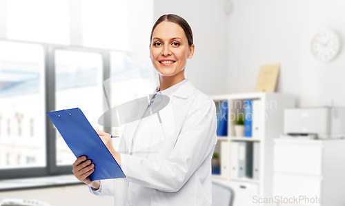 Image of smiling female doctor with clipboard at hospital