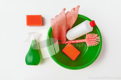 Image of basin with cleaning tools on white background