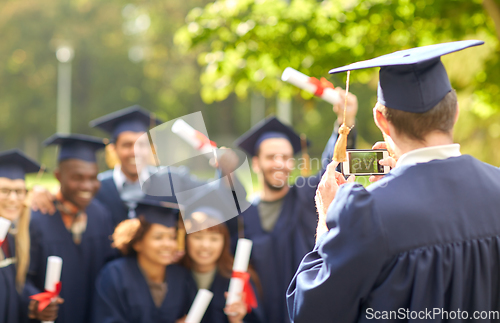 Image of graduate students taking photo with smartphone