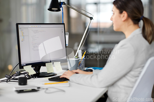 Image of businesswoman with computer working at office