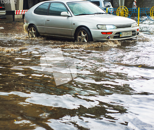 Image of Car driving flood city road