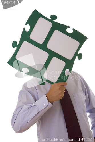 Image of businessman holding puzzle piece