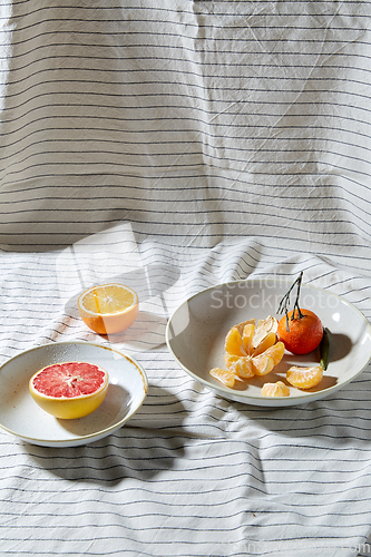 Image of still life with mandarins and grapefruit on plate