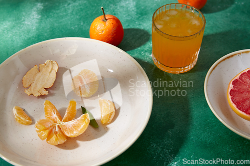 Image of mandarins, grapefruit and glass of juice