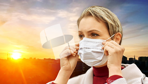 Image of young woman wearing protective medical mask