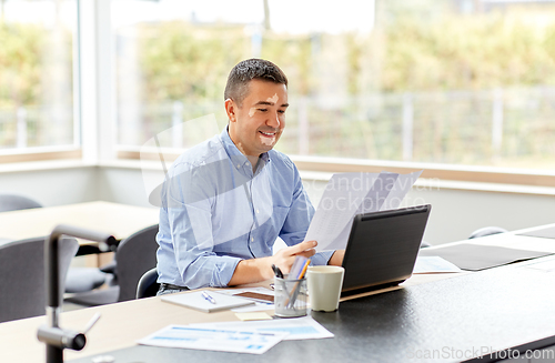 Image of middle-aged man with vitiligo working at home