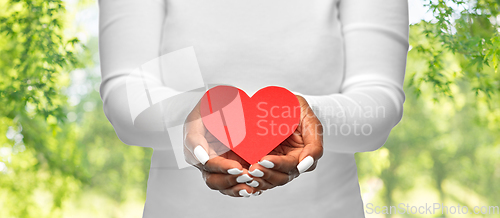 Image of close up of african american woman with red heart