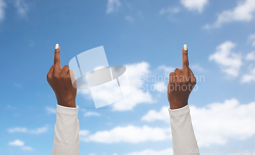 Image of hands of african woman showing middle fingers