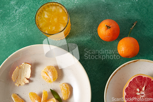 Image of mandarins, grapefruit and glass of juice