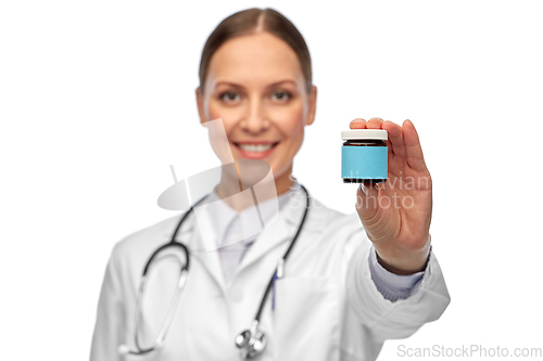 Image of smiling female doctor holding jar of medicine