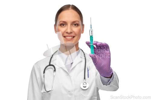 Image of smiling female doctor with medicine in syringe