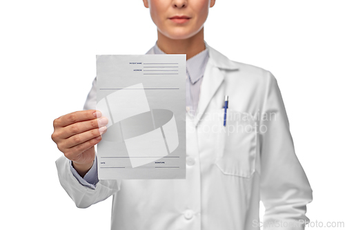 Image of close up of female doctor with prescription blank