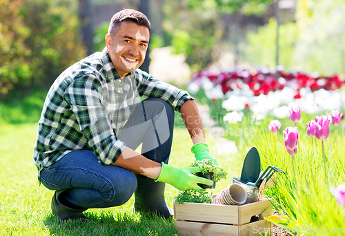 Image of middle-aged man with vitiligo working at garden