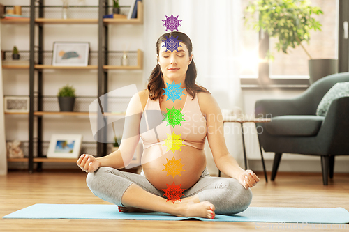 Image of pregnant woman meditating at home