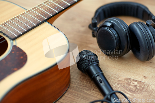 Image of close up of guitar, microphone and headphones