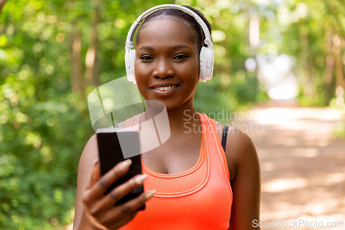 Image of african american woman with headphones and phone
