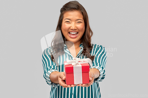 Image of happy asian woman with birthday present