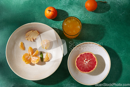 Image of mandarins, grapefruit and glass of juice