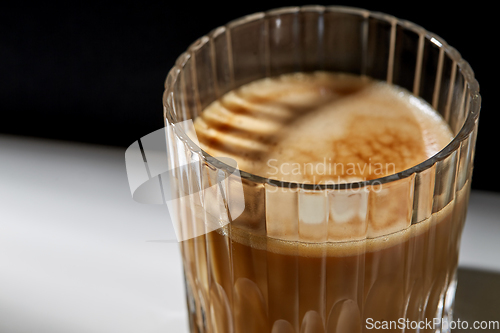 Image of close up of coffee in glass on table