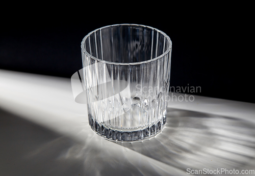 Image of empty faceted glass on table