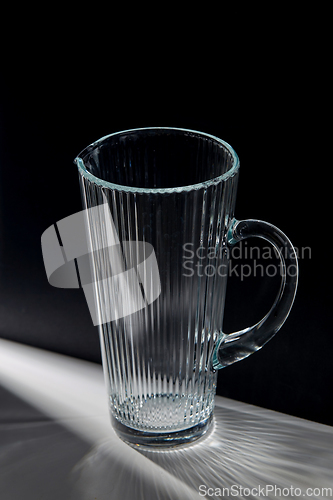 Image of empty faceted glass jug on table